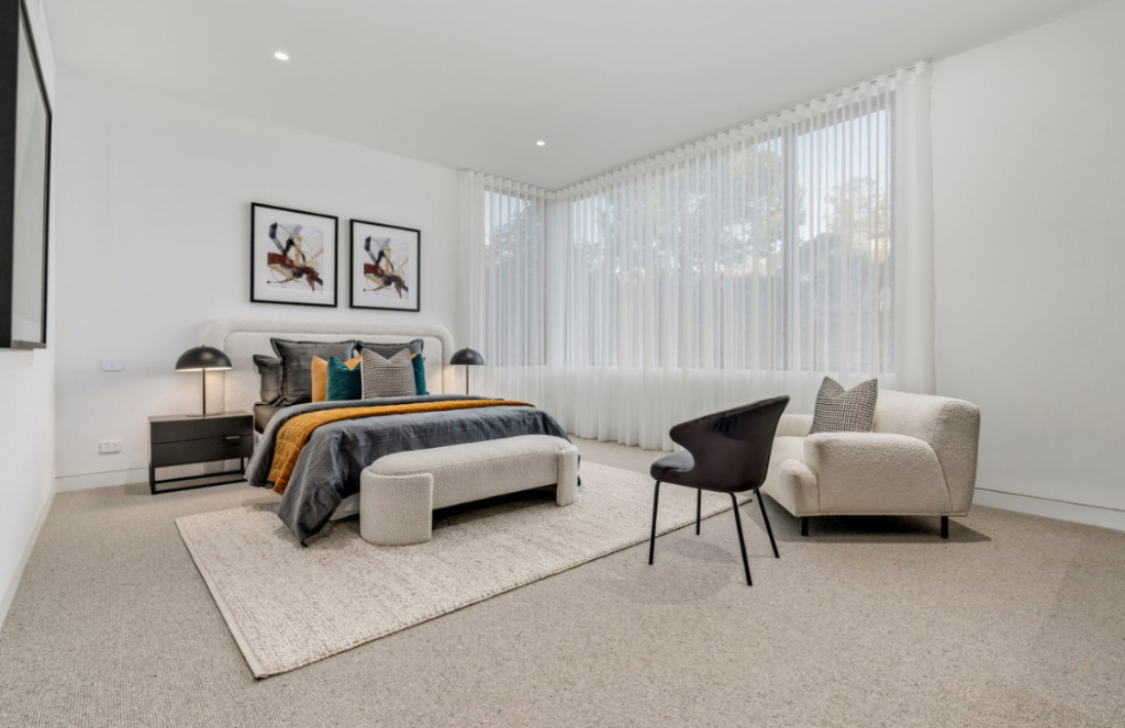 Luxury contemporary bedroom styling with warm caramel accents and layered textures