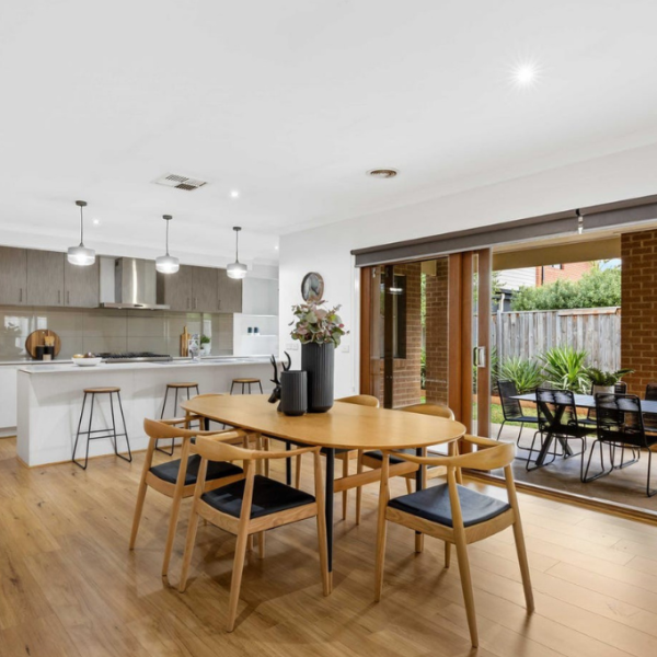 Contemporary open-plan dining and kitchen styling with warm timber finishes