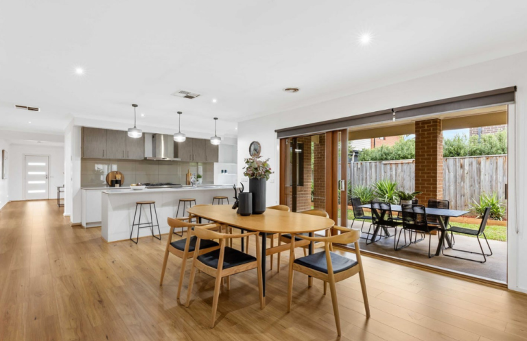 Contemporary open-plan dining and kitchen styling with warm timber finishes