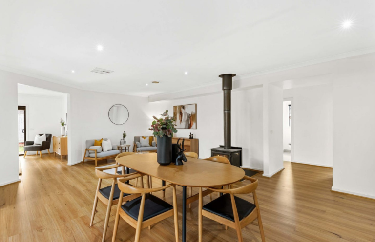 Contemporary open-plan dining and kitchen styling with warm timber finishes