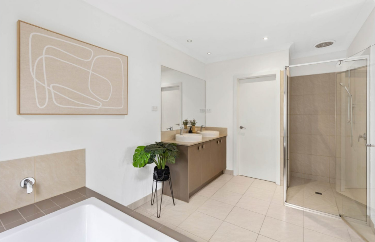 Warm contemporary bathroom with minimalist artwork and natural accents