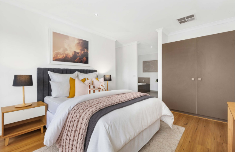 Modern Australian bedroom staging with layered textiles and natural tones