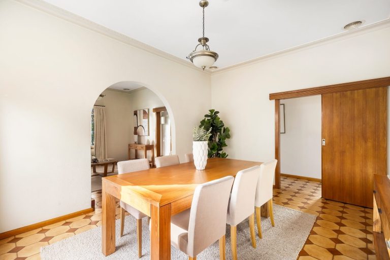 Vintage dining room styled with timber furniture, neutral tones, and soft textures to brighten the space